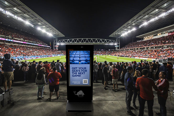 Digital sign that allows guests to upgrade their seats with their phone
